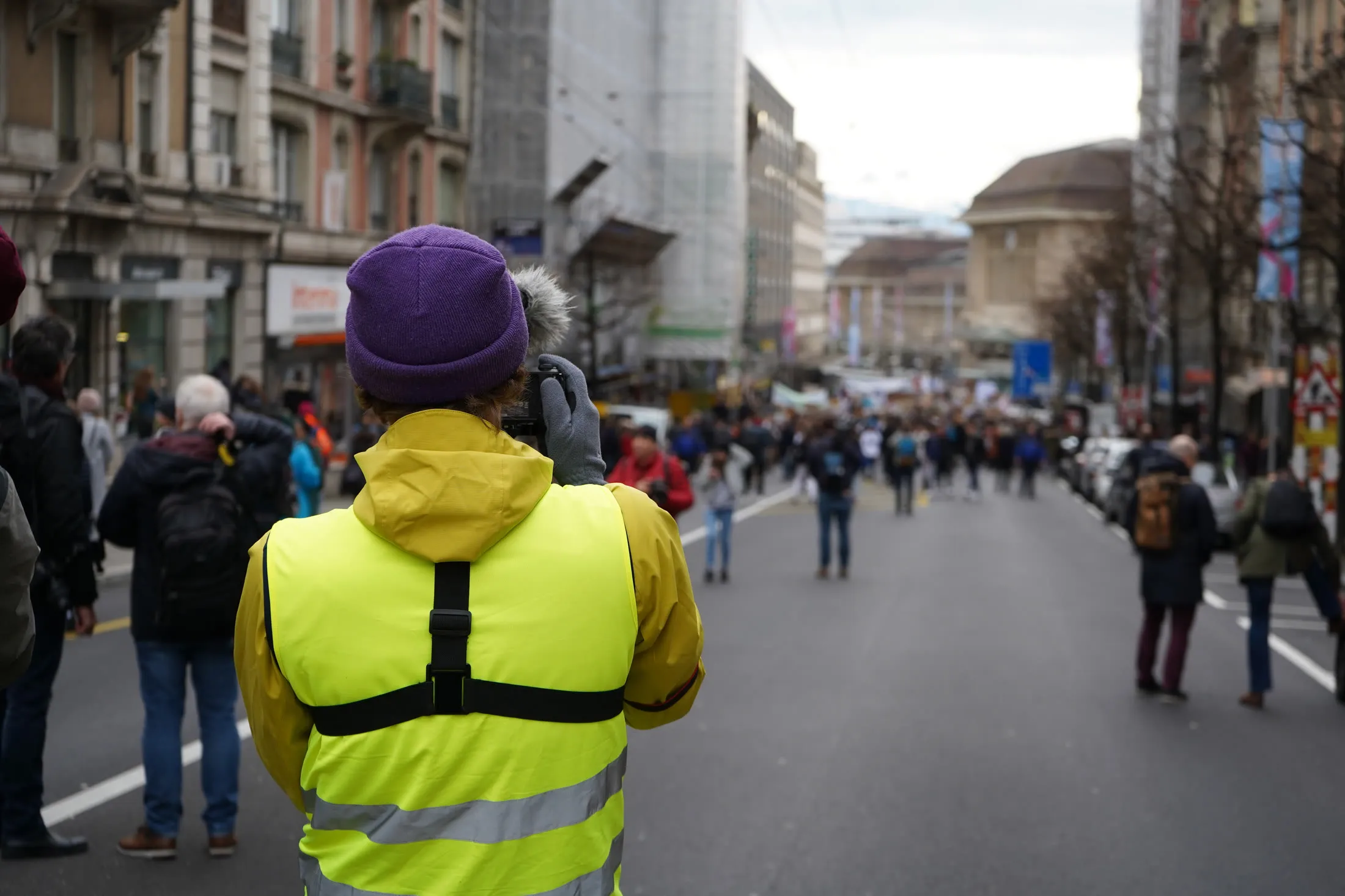Videographer filming a report in a Lausanne street