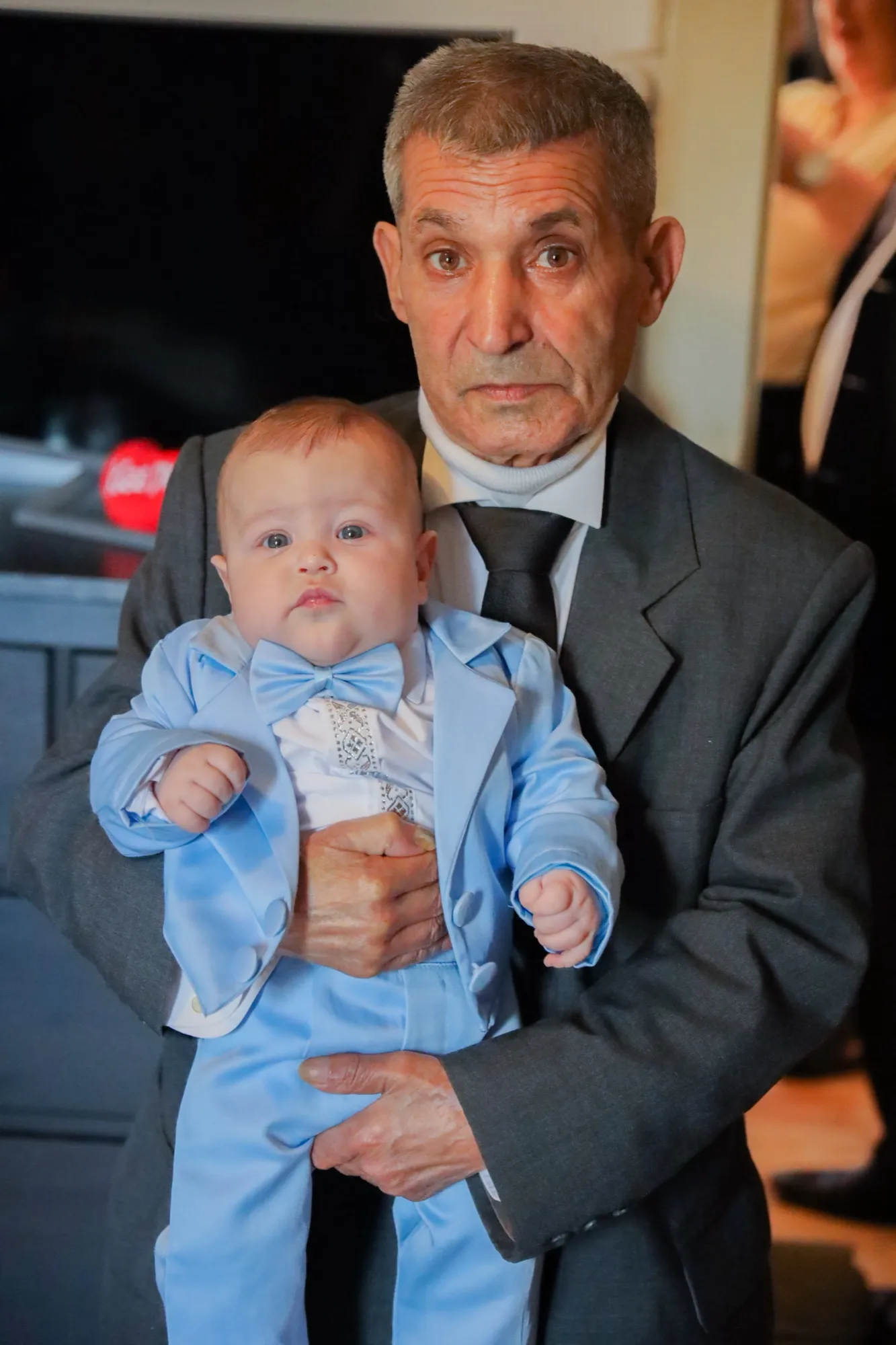 The grandfather holding the baby