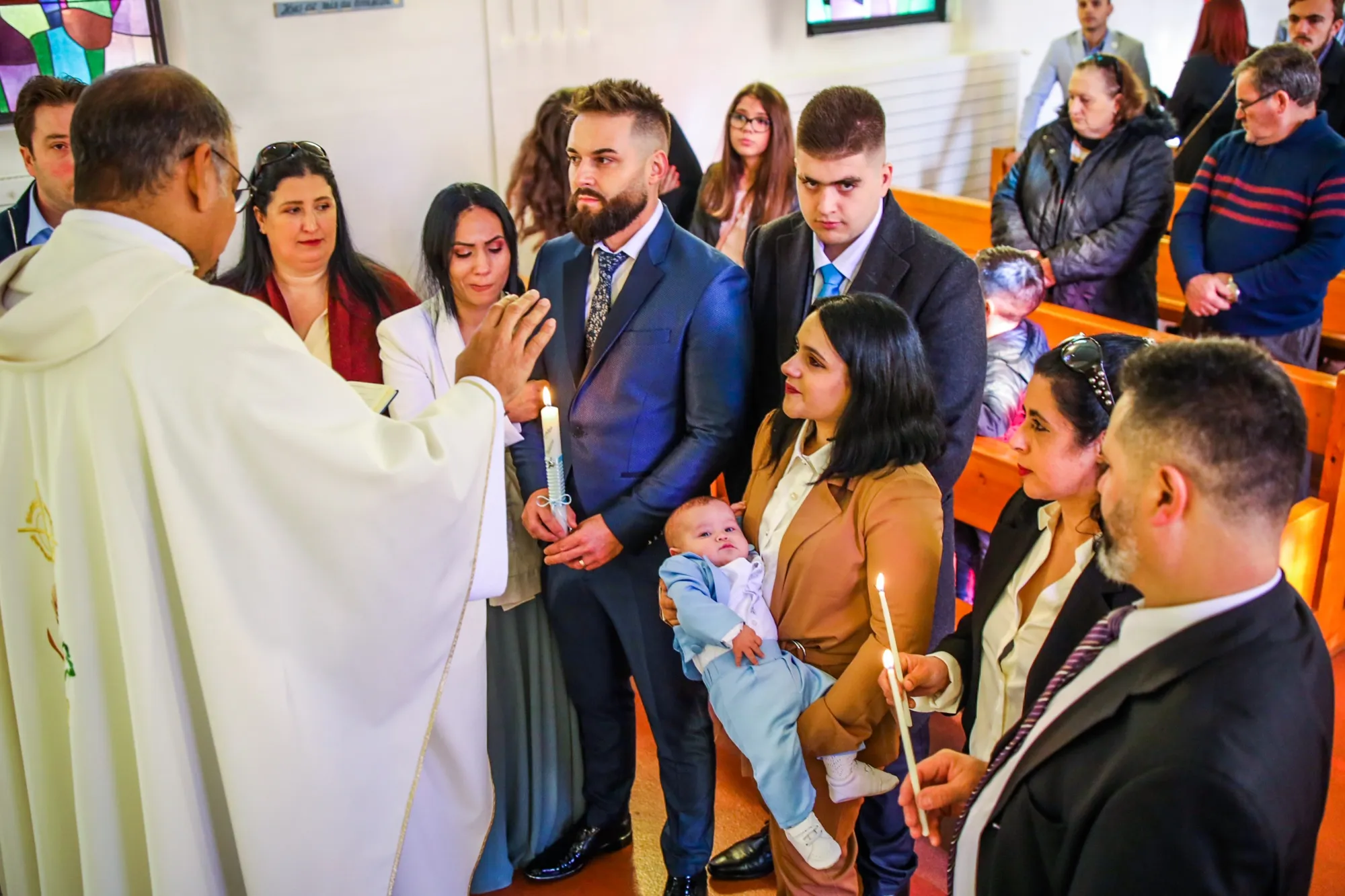 The family around the priest during the ceremony