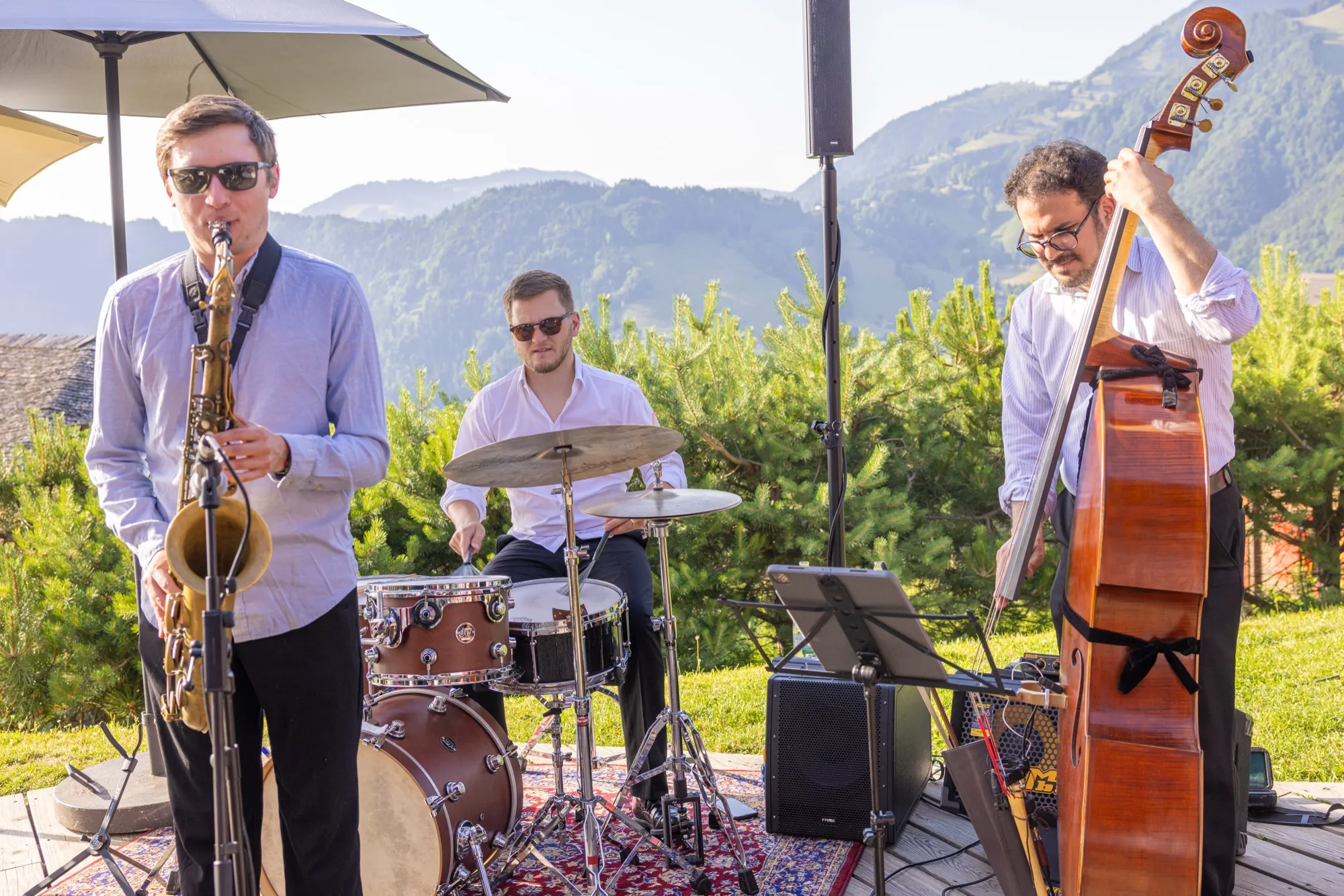 Jazz band playing on a terrace facing the lake and mountains