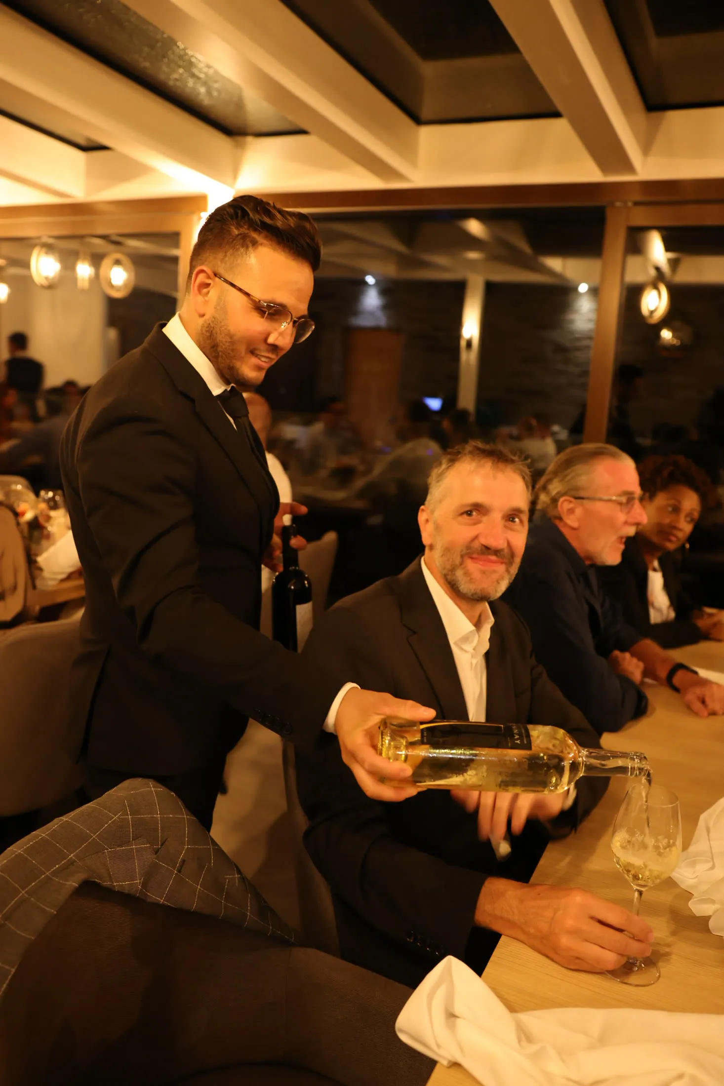 Wine being served at a company dinner
