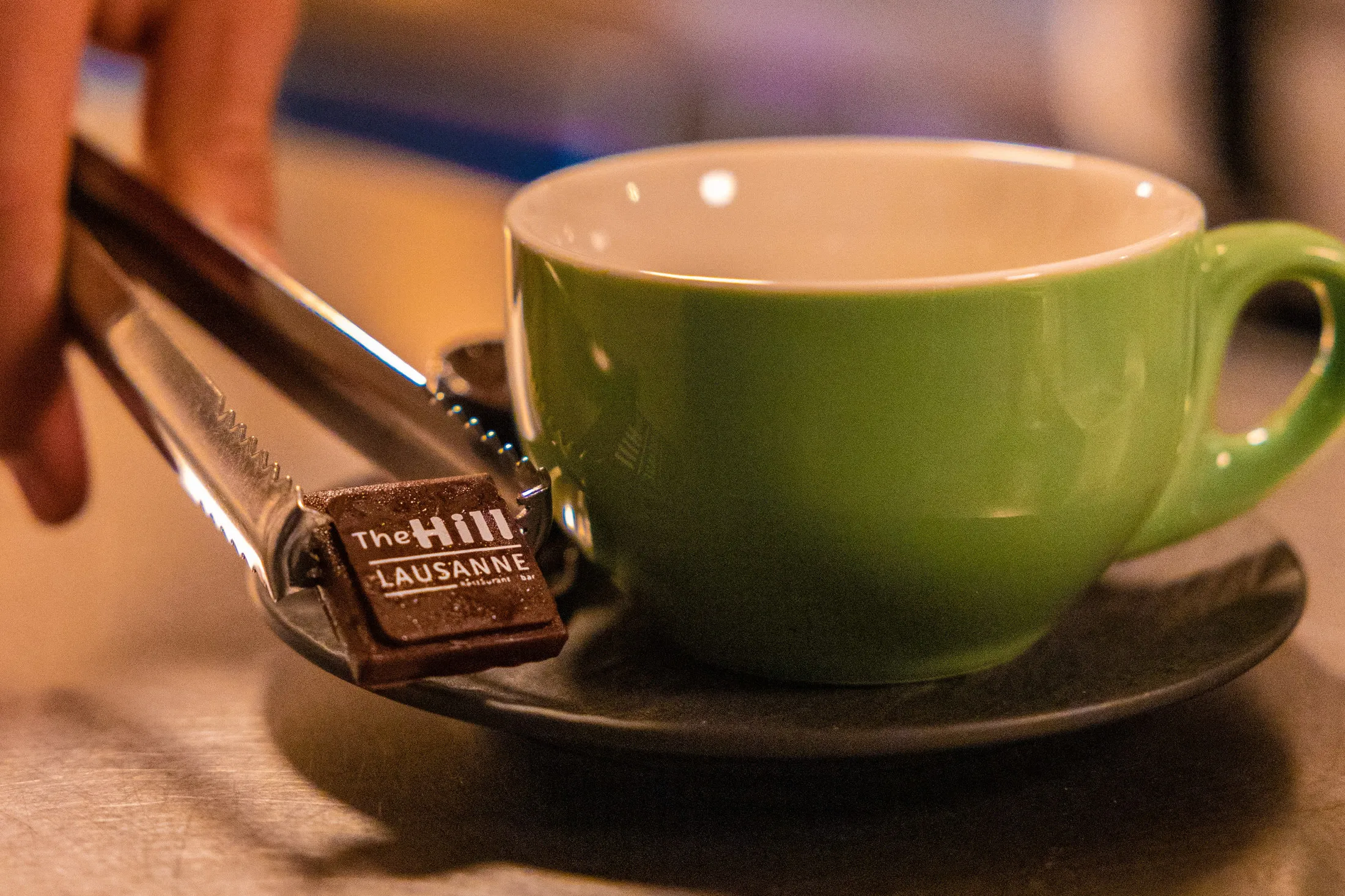 Green coffee cup and biscuit on a saucer