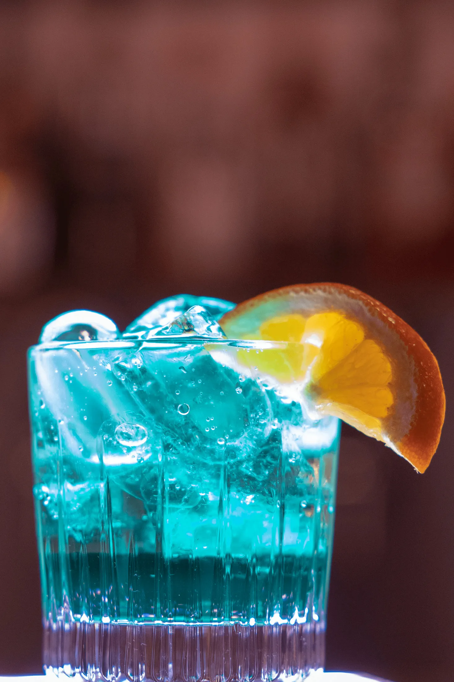 Blue cocktail with a slice of orange