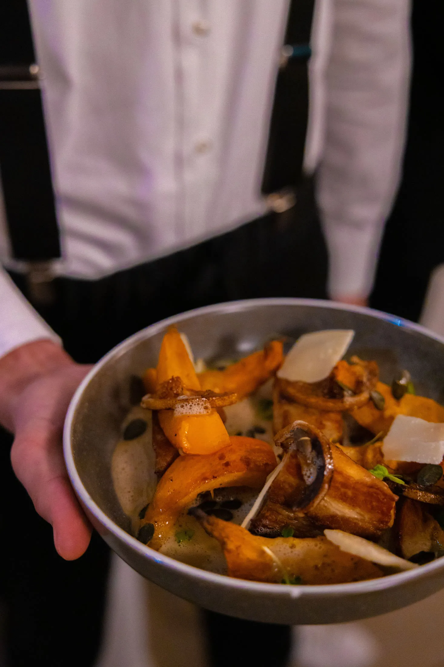 Waiter bringing out a dish, photographed for Instagram