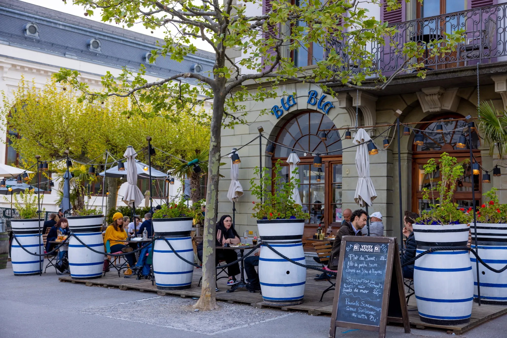 A restaurant terrace in town, under the trees
