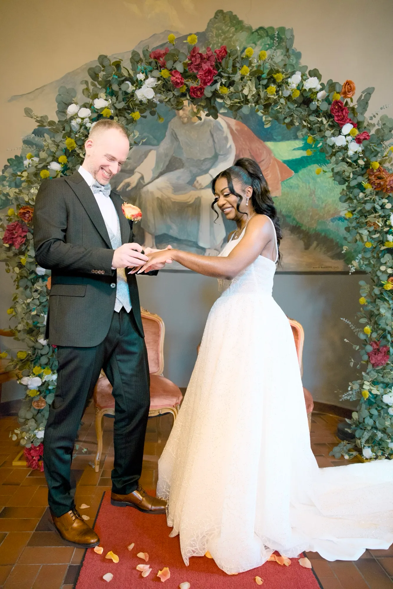 Exchanging rings under the flower arch