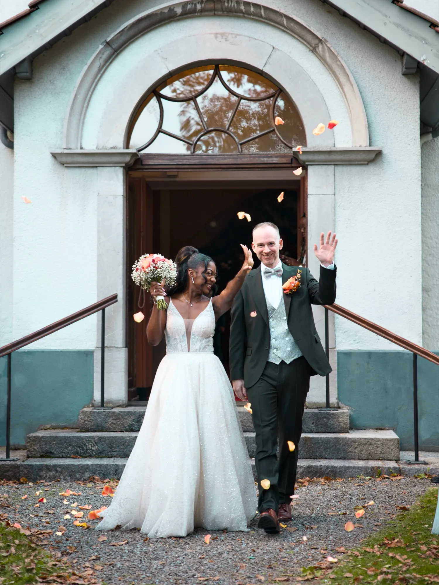 The couple walking out, arms raised