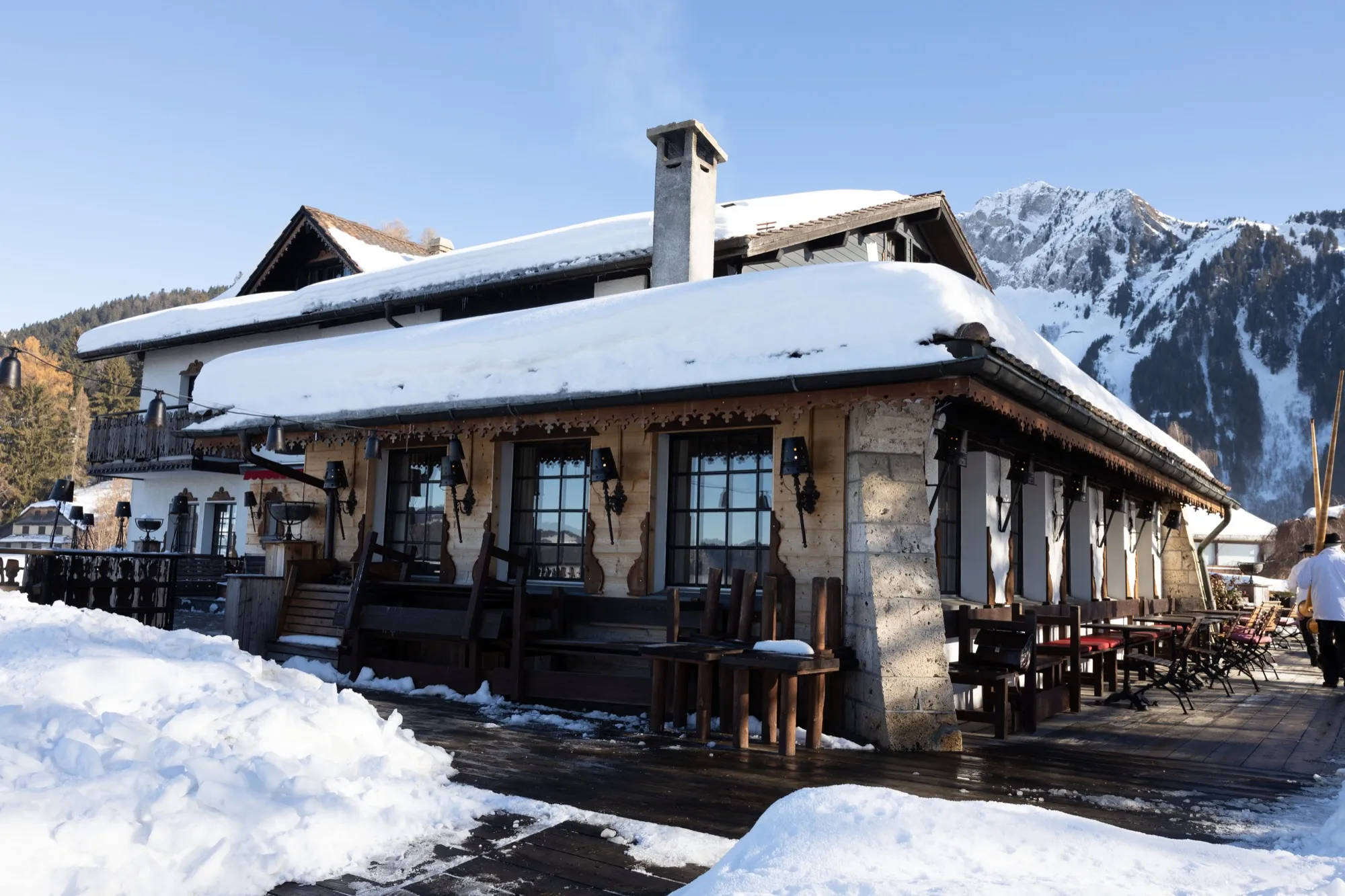Snow-covered chalet restaurant under a blue sky