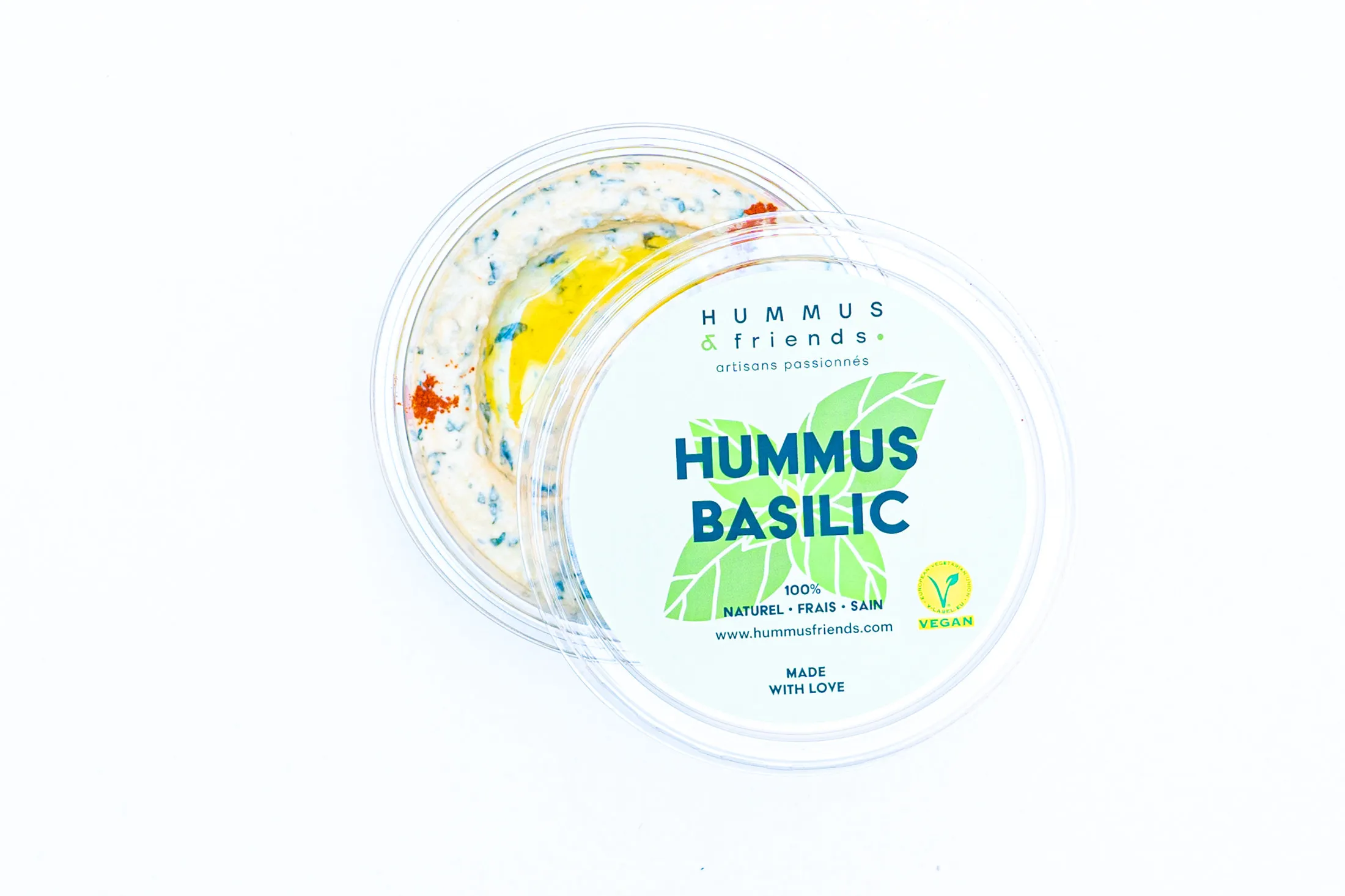 Product photo of a hummus tub on a white background