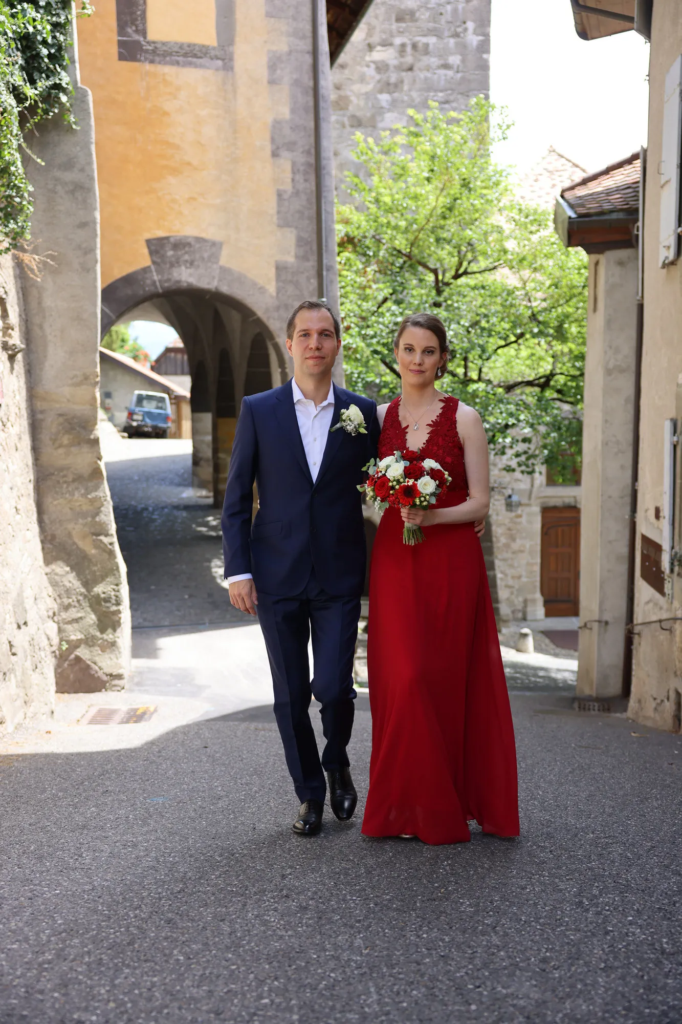 The newlyweds walking down a cobbled old-town lane